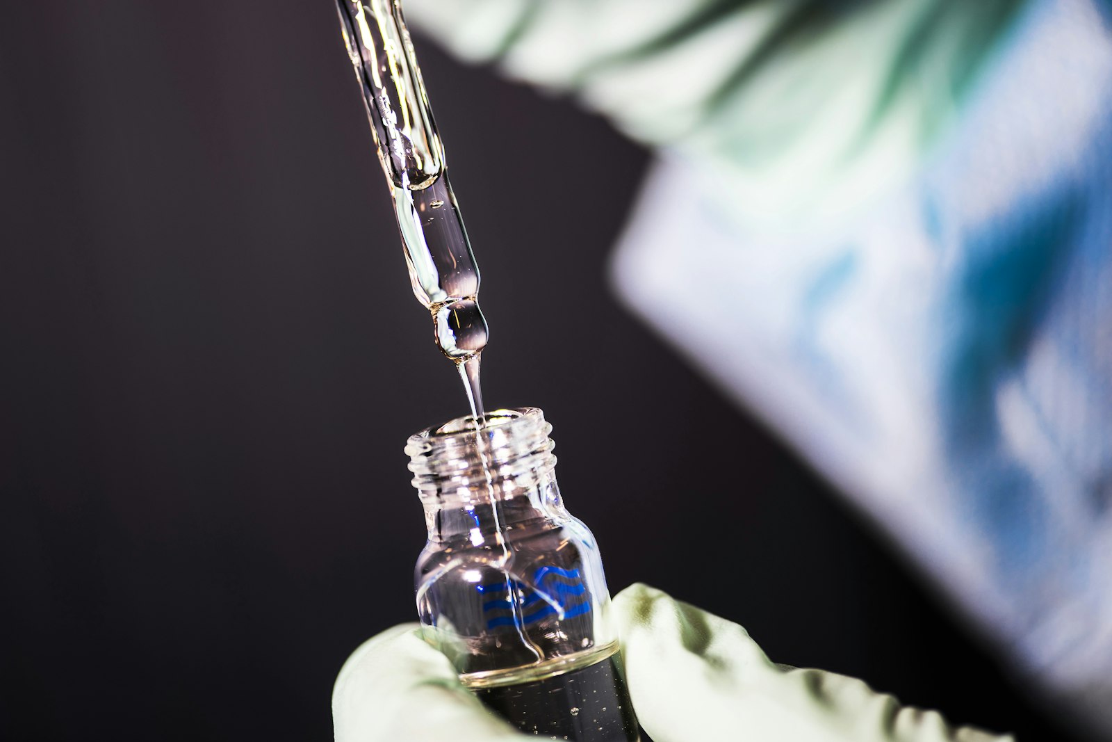 A clear injectable medication vial on a clinical surface, representative of the weekly subcutaneous GLP-1-class compounds discussed in this article.