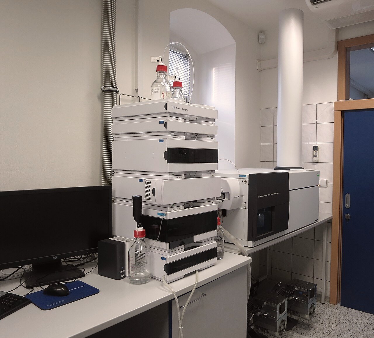 Liquid chromatograph coupled to a quadrupole time-of-flight mass spectrometer on a laboratory bench.